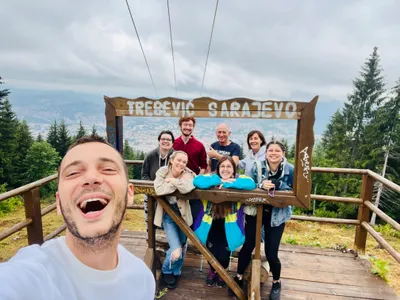 A tour group posing at the Trebevic Sarajevo viewpoint