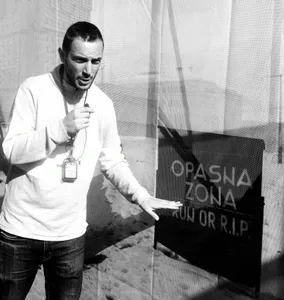 A tour guide explaining a Sarajevo siege danger zone
