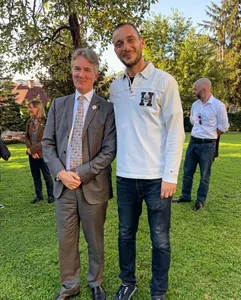 A tour guide together with Julian O’Reilly (British Ambassador) at a garden reception