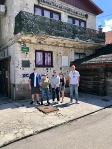 A tour group outside the bullet scarred Sarajevo Tunnel Museum