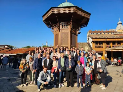 A tour group posing at the Sebilj fountain in Sarajevo old town