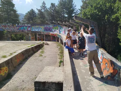 A tour group posing at the abandoned Olympic bobsled track