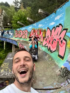 A tour group posing in a line on the Olympic bobsled track