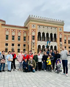 A tour group posing in front of Sarajevo City Hall