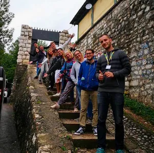 A tour group posing on the steps of the Yellow Fortress in Sarajevo