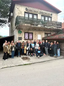 A tour group posing outside the Kolar family house at the Tunnel of Hope
