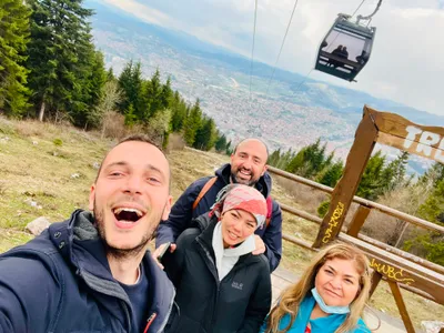 A tour group taking a selfie at the Trebevic Sarajevo viewpoint