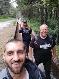A tour group taking a selfie while walking the Olympic bobsled track