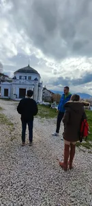 A tour guide speaking beside an Ottoman mausoleum