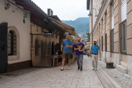 Three visitors walking through Sarajevo old town