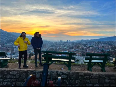Two men overlooking Sarajevo at sunset